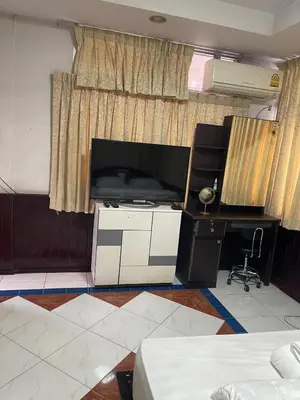 a living room with a desk and a large window at Home Rama 4 near BTS Thong Lor in Khlong Toei