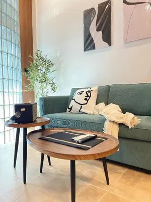 a living room with a green couch and a coffee table at Nueng Rana 113 Unique House in Chinatown 3BR 2BA - Villa in Samphanthawong