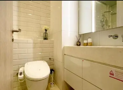 a white bathroom with a toilet and a sink at \u7d20\u5764\u9038\u6cbf\u7ebfBTS Ekkama Station in Bangkok
