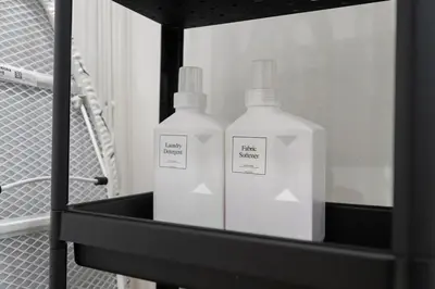 two bottles ofodorizers on a shelf in a bathroom at Moondance House Chinatown in Bangkok
