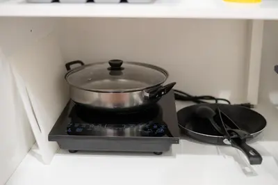 a pot on top of a stove in a kitchen at Moondance House Chinatown in Bangkok