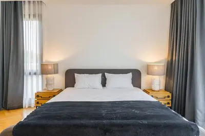 a bedroom with a large bed with two night stands at Designer 49 Pool Villa in Bangkok