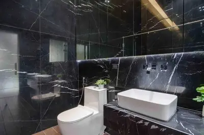a black bathroom with a toilet and a sink at Luxury Modern Pool Jacuzzi Villa 5BR Thonglor in Khlong Toei