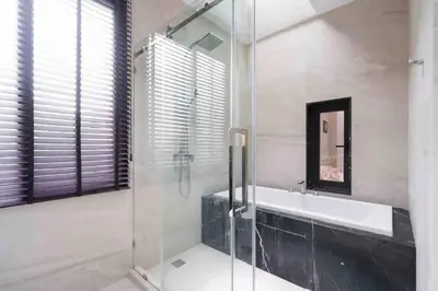 a bathroom with a tub and a sink and a mirror at Luxury Modern Pool Jacuzzi Villa 5BR Thonglor in Khlong Toei