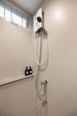 a shower with a shower head in a bathroom at Sunfire House Chinatown in Bangkok