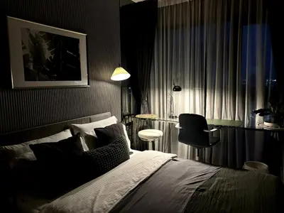 a bedroom with a bed and a table and a chair at City Oasis: 5 Min to Metro, Pool & Gym, Essentials in Khlong Toei