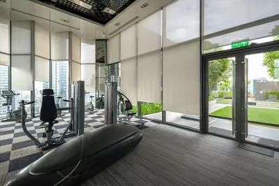 a fitness room with a gym with a treadmill at City Oasis: 5 Min to Metro, Pool & Gym, Essentials in Khlong Toei