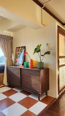 a room with a dresser with a plant and a window at Best River view, Retro vibe studio apartment - Bangkok Old Town in Bangkok