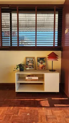 a living room with a table with a lamp and a window at Best River view, Retro vibe studio apartment - Bangkok Old Town in Bangkok
