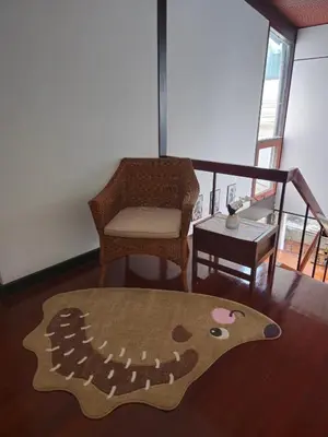 a living room with a chair and a rug at AT ASok Vintage House Near BTS Asok MRT Sukhumvit in Khlong Toei