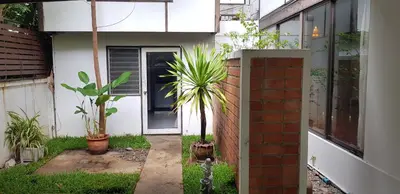 a house with plants in front of a door at AT ASok Vintage House Near BTS Asok MRT Sukhumvit in Khlong Toei