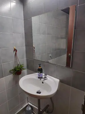 a bathroom with a sink and a mirror at AT ASok Vintage House Near BTS Asok MRT Sukhumvit in Khlong Toei