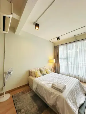 a bedroom with a bed and a large window at 260m walk to BTS Prakanong in Bangkok