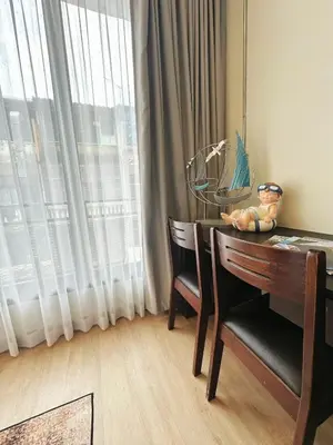 a dining room table with two chairs and a window at 260m walk to BTS Prakanong in Bangkok