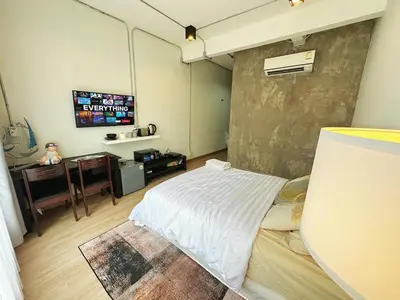 a room with a bed and a tv on a wall at 260m walk to BTS Prakanong in Bangkok