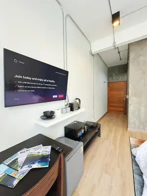a room with a flat screen tv on a wall at 260m walk to BTS Prakanong in Bangkok
