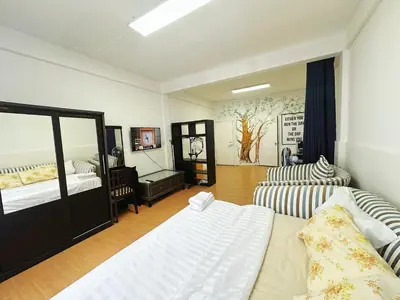 a living room with two beds and a couch at Top Location! 800m MRT Rama9 in Bangkok