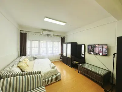 a living room with a couch and a bed at Top Location! 800m MRT Rama9 in Bangkok