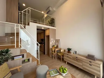 a living room with a staircase and a dining room at Rama9 Loft Life in Bangkok