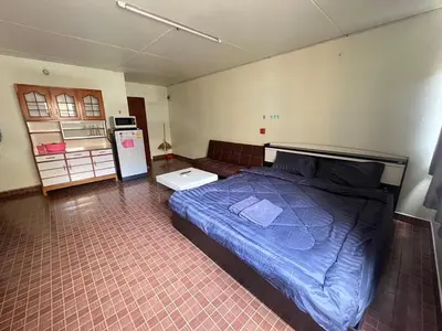 a bedroom with a bed and a refrigerator in it at ห้องเช่ารายวัน เมืองทองธานี C5 By ณดา in Ban Bang Phang