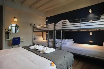 a bedroom with two bunk beds with towels at Baan Sri-kram 550m from MRT Taopoon in Bang Su