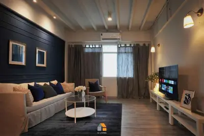 a living room with a couch and a table at Baan Sri-kram 550m from MRT Taopoon in Bang Su