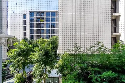 a view of a tall building with trees in front of it at TC Contel At BTS Onnut Century in Amphoe Phra Khanong