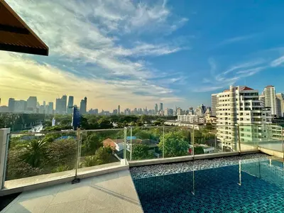a view of the city from the balcony of a building at Bright & Spacious Apartment in Bangkok