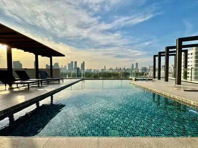 a swimming pool on the roof of a building at Bright & Spacious Apartment in Bangkok