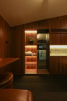 a room with wooden walls and a room with a refrigerator at baansaensaep in Pratunam