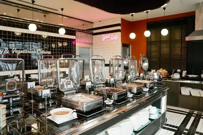 a buffet line in a restaurant with food at Vince Hotel Pratunam in Bangkok