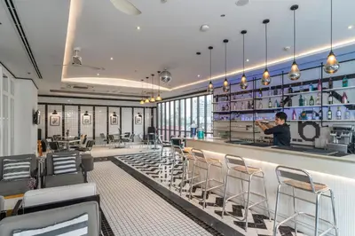 a man standing at a bar in a restaurant at Vince Hotel Pratunam in Bangkok