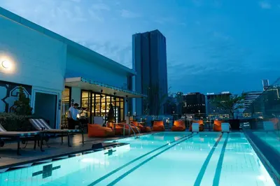 a swimming pool on the roof of a building at Vince Hotel Pratunam in Bangkok