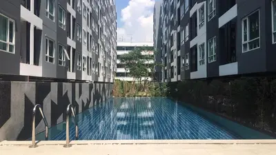 a swimming pool in the middle of a building at White Turquoise -1 Bedroom Apartment- in Bangkok
