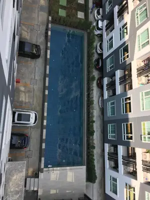 an overhead view of a swimming pool between two buildings at White Turquoise -1 Bedroom Apartment- in Bangkok