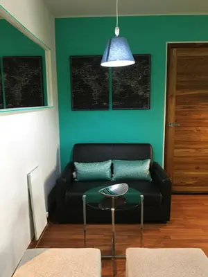 a living room with a black couch and a table at White Turquoise -1 Bedroom Apartment- in Bangkok