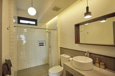 a bathroom with a sink and a toilet and a mirror at Stylish Studio in Prime Sukhumvit-Next to BTS Nana in Bangkok