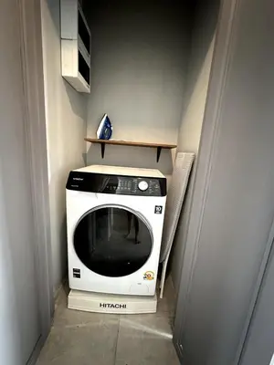 a microwave sitting on a shelf in a room at Stylish Studio in Prime Sukhumvit-Next to BTS Nana in Bangkok