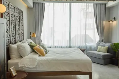 a bedroom with a bed and a large window at Stylish Studio in Prime Sukhumvit-Next to BTS Nana in Bangkok