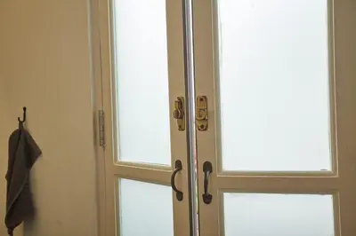 a glass door with two windows in a bathroom at Spacious duplex 2 BR apartment max 6 guests - 3 min walk to BTS Nana in Bangkok