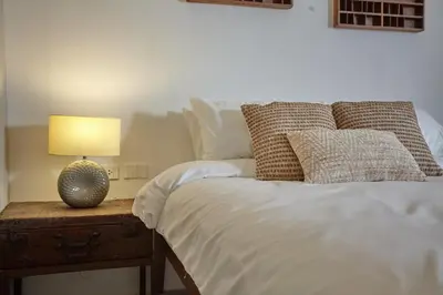 a bedroom with a bed with a lamp on a table at Stylish duplex 2 BR apartment - 3 mins walk to BTS Nana in Bangkok