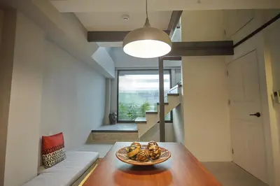 a room with a table with a bowl of fruit on it at Stylish duplex 2 BR apartment - 3 mins walk to BTS Nana in Bangkok