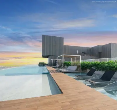 a swimming pool with two chairs and a building at Luxury Riverside Condo, 3 SKY Pools , Close to MRT Train Station in Ban Sai Ma