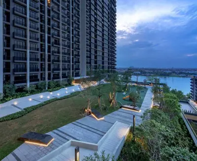 a view of a large building with a garden at Luxury Riverside Condo, 3 SKY Pools , Close to MRT Train Station in Ban Sai Ma