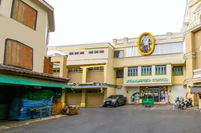 a building with a clock on the side of it at OYO 895 The Onion Hostel in Bangkok