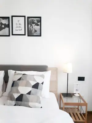 a bedroom with a bed with a table and pictures on the wall at Oh Boutique Guesthouse. in Bangkok