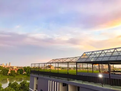 a view of a building with a rainbow in the sky at Delighted Bangkok Hotel in Bangkok