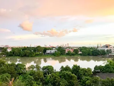 a view of a river with a city in the background at Delighted Bangkok Hotel in Bangkok