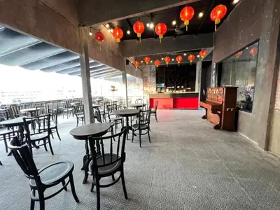 a dining room with tables and chairs and lights at 2499 Heritage Chinatown Bangkok Hotel By RoomQuest in Bangkok