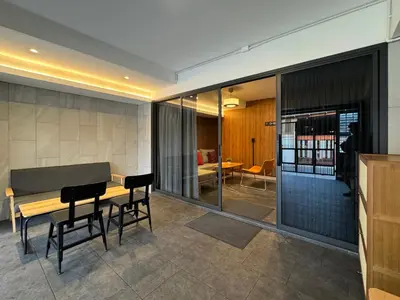 a living room with a table and chairs and a dining room at Hyde Residence Ladprao48 in Bangkok
